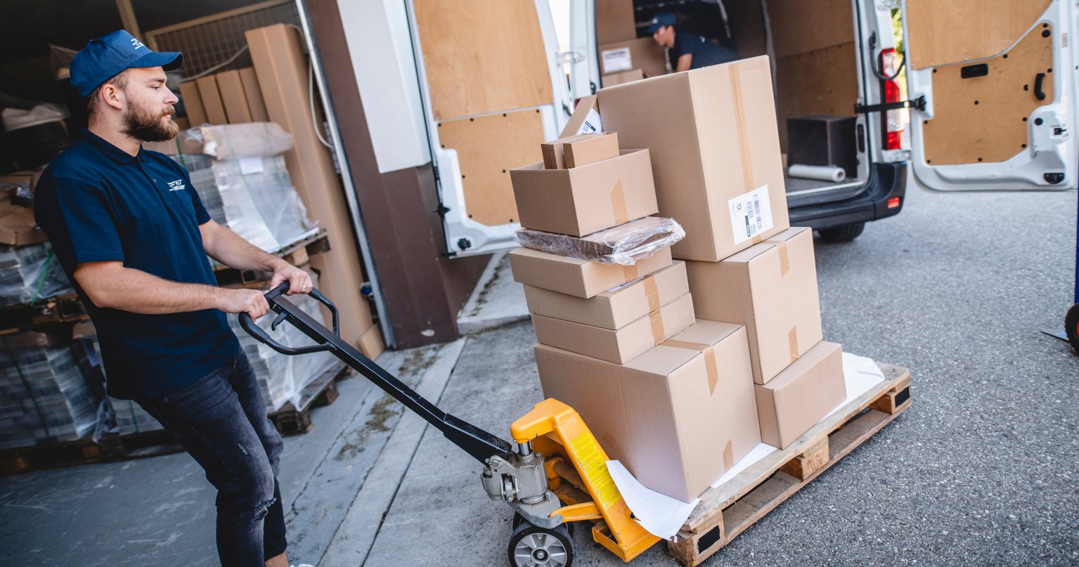 Male Gig Delivery Driver Pushing Pallet Jack to Van