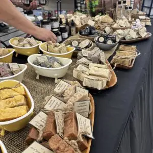 A variety of fresh soaps on tables.